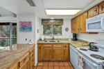 The kitchen is well-equipped with granite counter tops and modern amenities